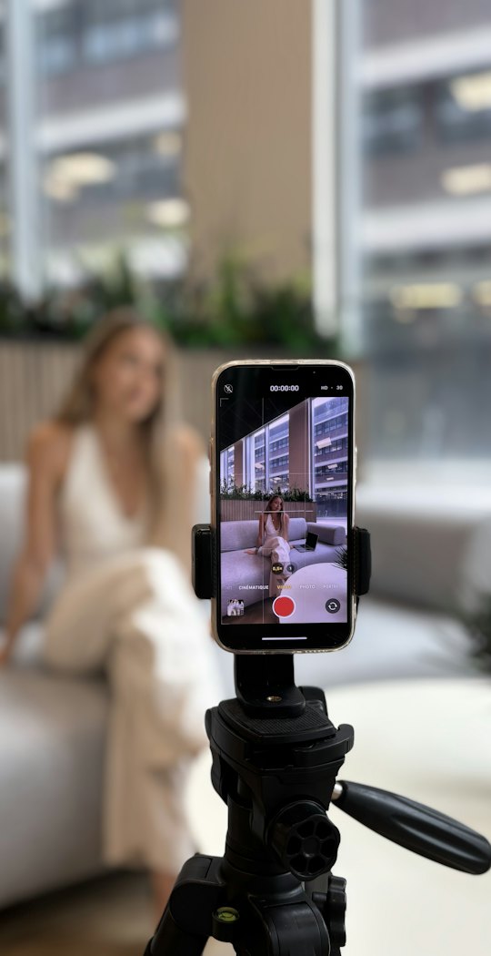 Phone on a tripod recording a person on a sofa